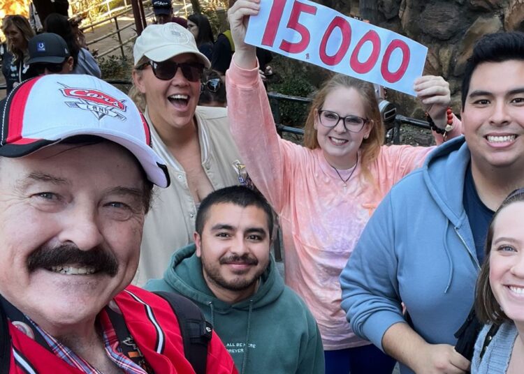 In this photo provided by Jon Alan Hale, Hale, left, poses with friends after taking his 15,000th Radiator Springs Racers ride at Disney California Adventure in Anaheim, Calif., on Monday. (Jon Alan Hale via AP)