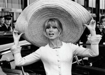 French actress Brigitte Bardot poses with a huge sombrero she brought back from Mexico, as she arrives at Orly Airport in Paris, France, on May 27, 1965. (AP Photo/File)