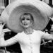 French actress Brigitte Bardot poses with a huge sombrero she brought back from Mexico, as she arrives at Orly Airport in Paris, France, on May 27, 1965. (AP Photo/File)