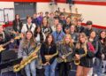 Students in jazz band pose with their instruments.
