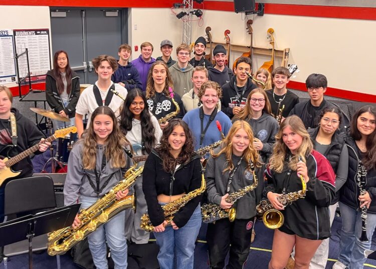 Students in jazz band pose with their instruments.