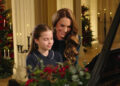 Princess Charlotte and Catherine, The Princess of Wales, sit smiling at a piano as they perform at for a Christmas Carol service