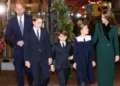 PA Media Prince William, Prince George and Prince Louis are seen walking outside the Abbey wearing suits, shirts and ties, while their sister Charlotte, wearing a dress with a peter pan collar, looks up at their mother Catherine, who wears a green coat with a furry collar