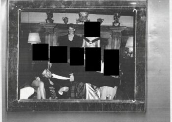 A redacted photo showing Andrew Mountbatten-Windsor laying across several people’s laps with Ghislaine Maxwell standing above. Photo: US Department of Justice via AP