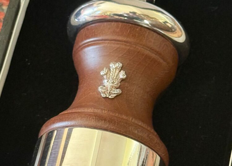 A wooden and silver salt shaker with a Prince of Wales feather