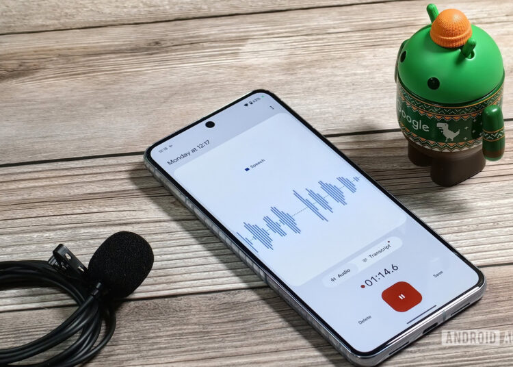 A Bot looking at a Pixel 8 Pro running the Pixel Recorder app next to a wired microphone
