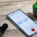 A Bot looking at a Pixel 8 Pro running the Pixel Recorder app next to a wired microphone