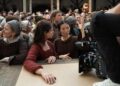 Actors Jessie Buckley and Joe Alwyn with director Chloé Zhao on the set of their film HAMNET