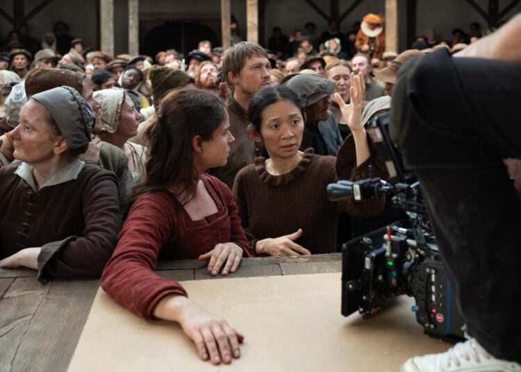 Actors Jessie Buckley and Joe Alwyn with director Chloé Zhao on the set of their film HAMNET