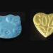 Pressed mdma pills in a Hello Kitty shape and a love heart shape.