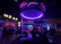 Bright visuals greet guests as they enter the lobby of Holey Moley at Irvine Spectrum Center.