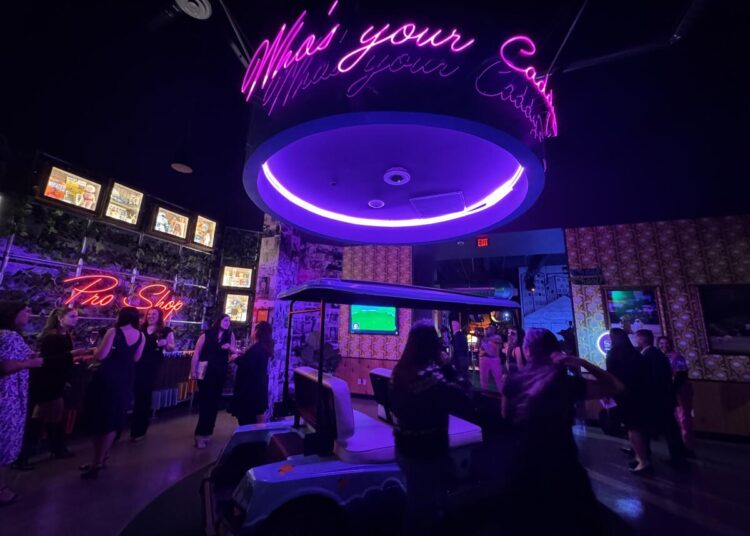 Bright visuals greet guests as they enter the lobby of Holey Moley at Irvine Spectrum Center.