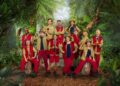 I'm a Celebrity 2025 cast stood around next to each other, smiling ahead in I'm a Celebrity outfits.