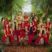 I'm a Celebrity 2025 cast stood around next to each other, smiling ahead in I'm a Celebrity outfits.