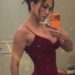 a person taking a selfie in a red dress with sparkles