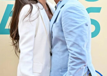 Axelle/Bauer-Griffin/FilmMagic From Left: Caitlin McHugh and John Stamos at 'The Beach Boys' premiere in May 2024