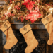 Golden Christmas stockings hang on a festive fireplace decked in red and gold at Dumfries House, one of the homes of King Charles in Scotland