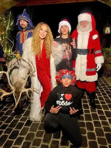 Mariah Carey/Instagram Mariah Carey shares photo with Santa Claus and twins Moroccan and Monroe
