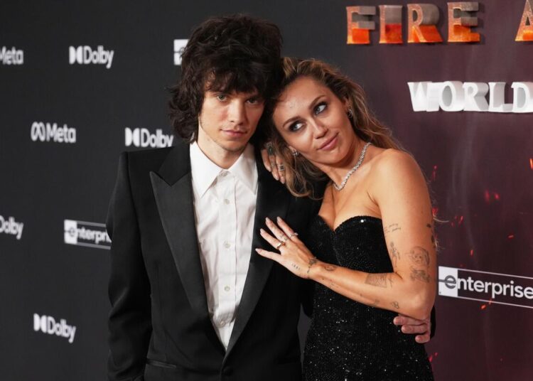 Miley Cyrus arrives with Maxx Morando at the premiere of "Avatar: Fire and Ash" on Monday  at Dolby Theatre in Los Angeles.
