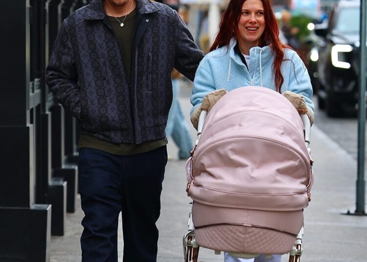 *exclusive* new york, ny **web must call for pricing** millie bobby brown, now known as millie bonnie bongiovi, and husband jake bonjovi were seen this afternoon in the west village, shopping at golden goose while strolling their daughter in a large pink stroller. milie was cozied up wearing chloe x moon boots and pushing their pink cartridge. jake showed off his blonde locks as he grabbed coffee for him and millie. pictured: millie bobby brown, jake bongiovi backgrid usa 10 december 2025 byline must read: blayzenphotos / backgrid usa: +1 310 798 9111 / usasales@backgrid.com uk: +44 208 344 2007 / uksales@backgrid.com *uk clients pictures containing children please pixelate face prior to publication*