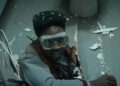 Caleb McLaughlin's Lucas coming through the floor wearing goggles.