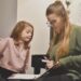 teacher working with a student