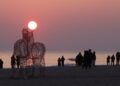 Tourists watch the sun rise at Gyeongpo Beach in Gangneung, Gangwon Province, Sunday, a few days ahead of the start of 2026. Yonhap