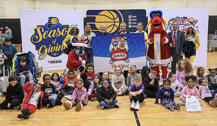 Children gather with Pacers Sports & Entertainment staff, Indiana Pacers mascot Boomer, Indiana Fever mascot Freddy Fever, Indiana Pacemates, Muncie Mayor Dan Ridenour and Muncie Police Department Deputy Chief Melissa Criswell for the Big Toy Giveaway at Muncie Central High School on Tuesday, Dec. 9, 2025.