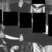 A black and white image showing Andrew lying across the laps of people