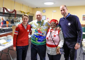 Prince William and Prince George with staff at a homeless shetler