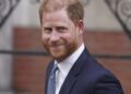 Prince Harry smiles towards the media as he leaves the Royal Courts of Justice in London, Tuesday, April 8, 2025