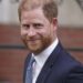 Prince Harry smiles towards the media as he leaves the Royal Courts of Justice in London, Tuesday, April 8, 2025