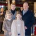 Princess Charlene, Prince Albert, Prince Jacques and Princess Gabriella posing at a Christmas event
