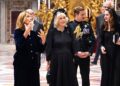 Major Ollie Plunket, pictured standing behind Queen Camilla, has served as Her Majesty's first-ever equerry since 2022