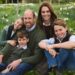 Prince William, Princess Kate, Princess Charlotte, Prince Louis and Prince George sitting in a field of flowers