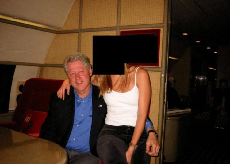 Former U.S. President Bill Clinton and a woman are seen in this image from the estate of late financier and convicted sex offender Jeffrey Epstein, released by the Department of Justice in Washington, D.C., U.S., on December 19, 2025. U.S. Justice Department/Handout via REUTERS THIS IMAGE HAS BEEN SUPPLIED BY A THIRD PARTY REDACTED AREAS FROM SOURCE. TPX IMAGES OF THE DAY THIS PICTURE WAS PROCESSED BY REUTERS TO ENHANCE QUALITY. AN UNPROCESSED VERSION HAS BEEN PROVIDED SEPARATELY.