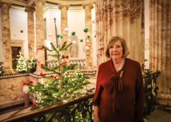 Lady Anne Glenconner in front of Christmas tree at Holkham Hall