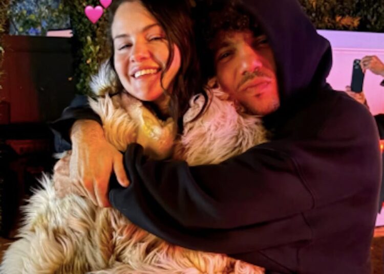 two individuals embracing surrounded by colorful lighting