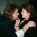 Ozzy Osbourne staring at his wife Sharon as she touches his face