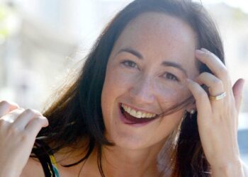 Author Sophie Kinsella poses on Wimbledon Village high street, London, Sept. 9, 2004. (AP Photo/Adam Butle, File)