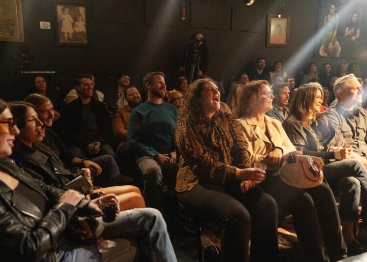 The crowd reacts to Ahmed Bharoocha's stand-up comedy performance.