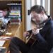 Tim Blake Nelson playing the guitar at his loft in New York City