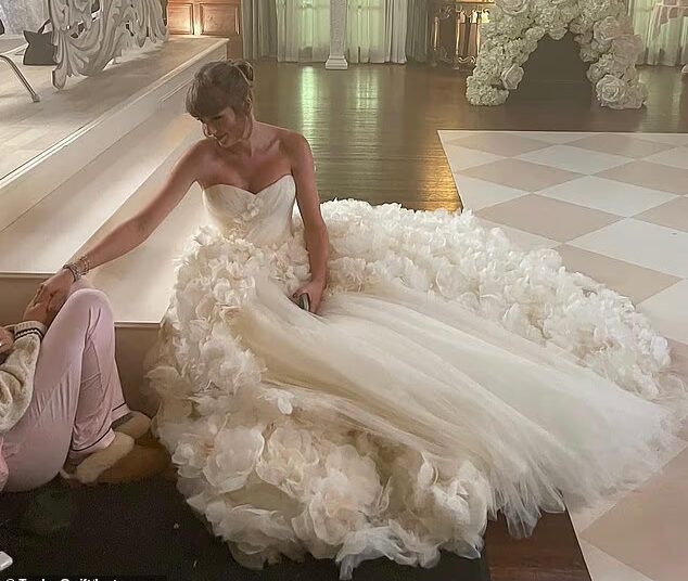 Taylor Swift has sparked speculation about the designer of her wedding dress after rumours that she met with Sarah Burton while in London. Pictured while filming I Bet You Think About Me in 2021