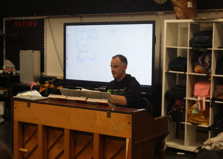 Students begin a demanding rehearsal process by learning the entire Chicago score, blending classroom focus with pop culture familiarity.