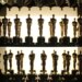Multiple Oscar statuettes on shelves backstage.