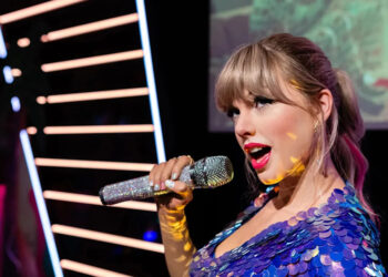 Taylor Swift singing on stage.