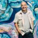Man standing against graffiti wall