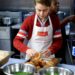 Prince George handling Yorkshire puddings at a homeless shelter