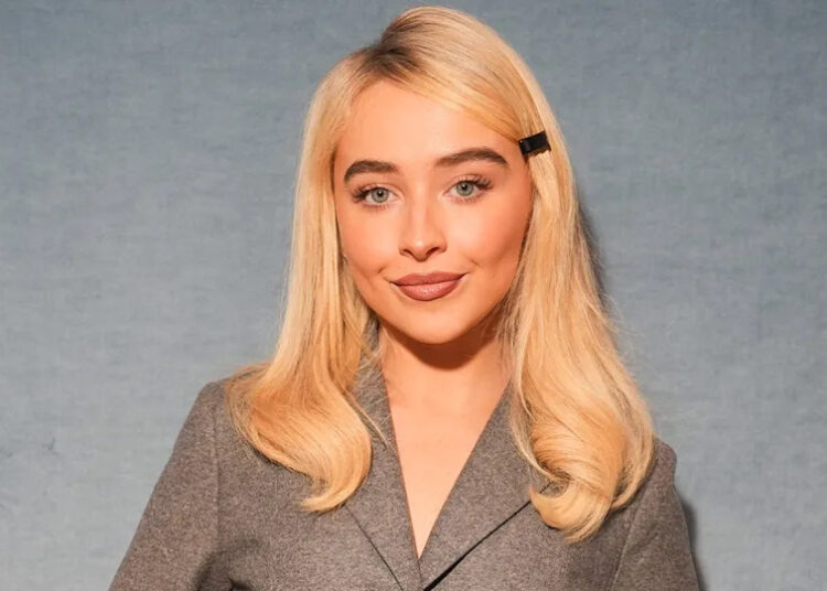 Sabrina Carpenter wears grey blazer at Dior fashion show.