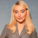 Sabrina Carpenter wears grey blazer at Dior fashion show.